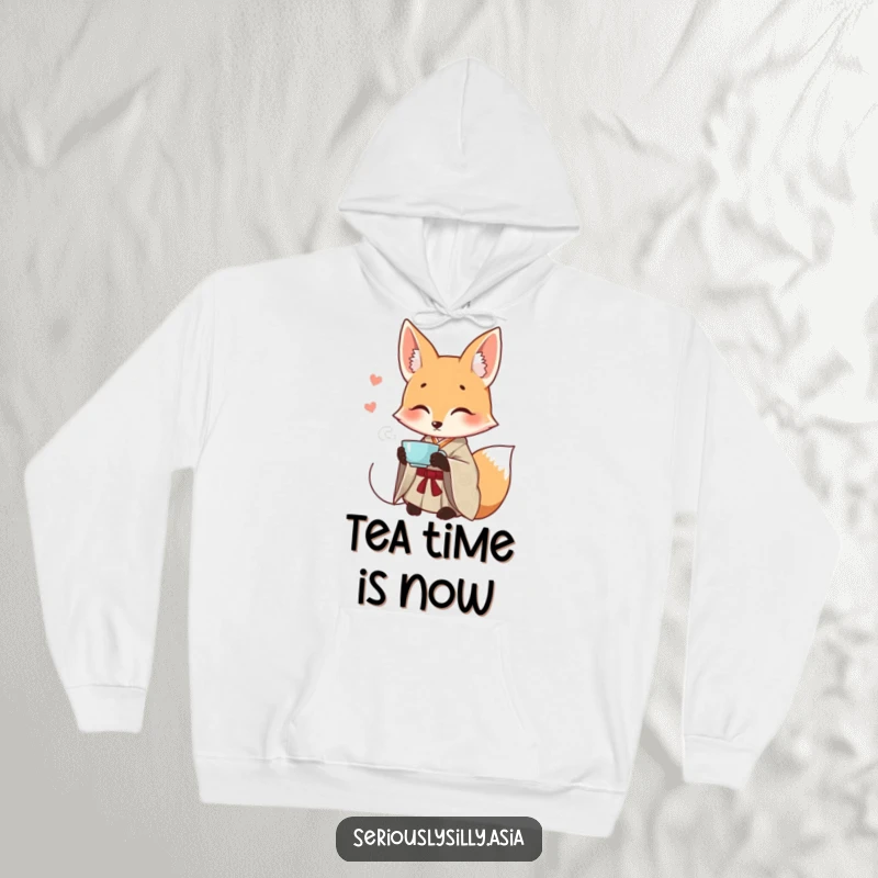 Funny hoodie with a smiling cartoon fox wearing a patterned kimono, elegantly sipping tea in a relaxed pose.