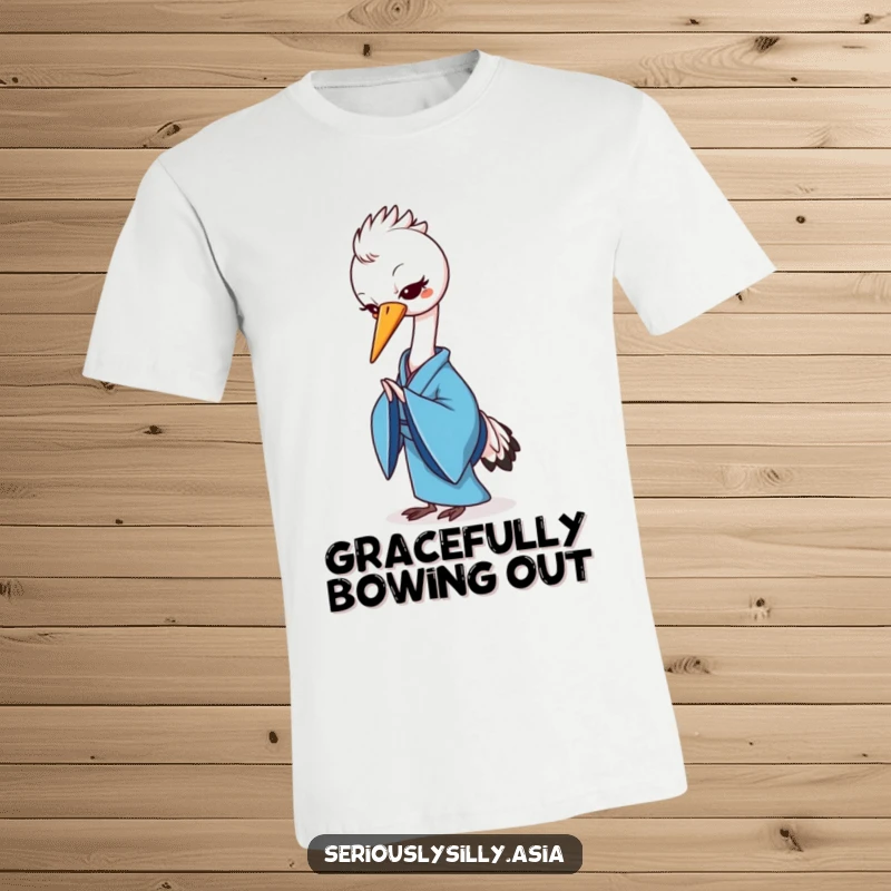 Funny t-shirt featuring a cheerful cartoon crane in a blue kimono, gracefully bowing with serene charm.