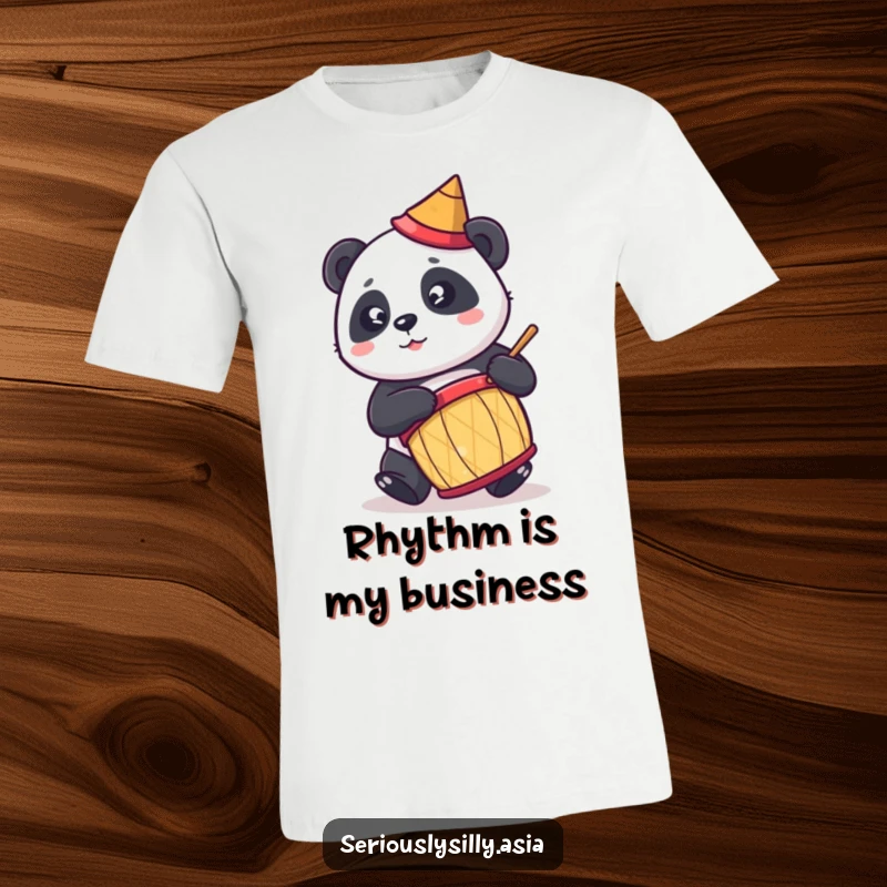 Funny t-shirt with a cute cartoon panda in a conical hat, enthusiastically playing a drum, ready to rock.