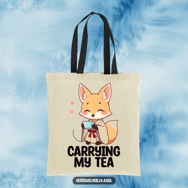 Funny tote bag featuring a smiling cartoon fox in a patterned kimono, gracefully sipping tea.